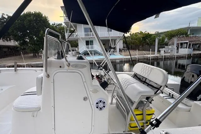 Slide: The Image of 2003 Sea Pro 206 Center Console boat docked by waterfront homes. - 8