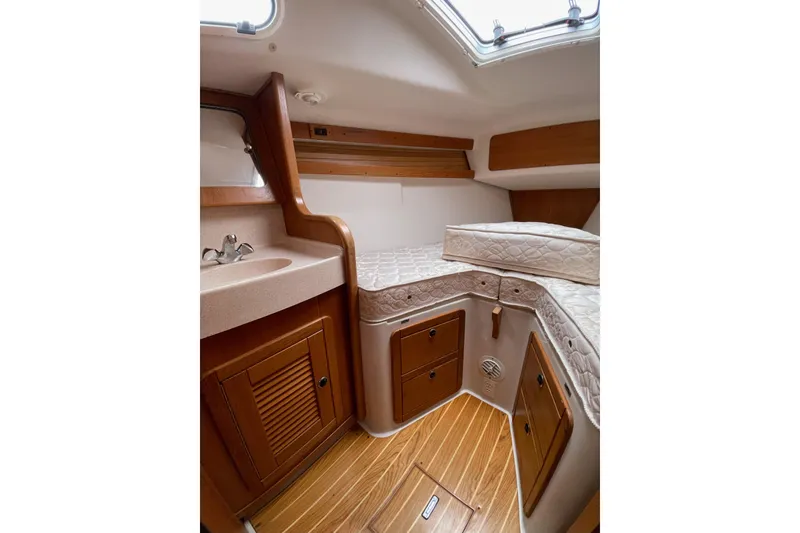 Slide: The Image of Interior cabin of 2001 Catalina 380 sailboat with wooden flooring and compact sink. - 6
