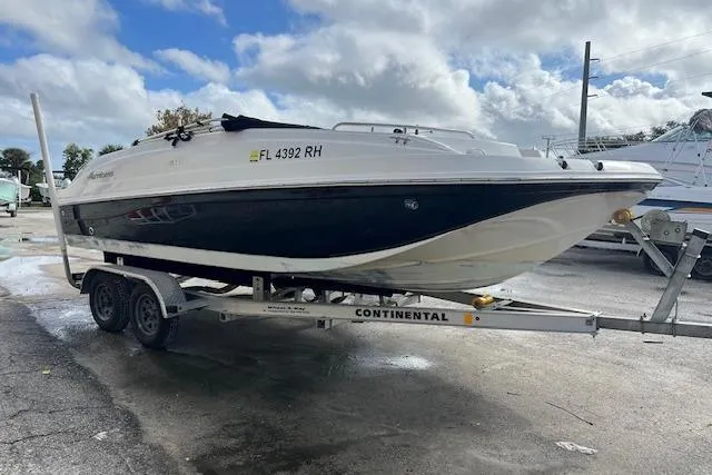 The Image of 2017 Hurricane SunDeck Sport 188 OB boat on a trailer, parked outdoors. - 0
