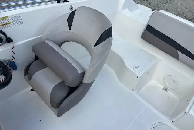 Slide: The Image of 2017 Hurricane SunDeck Sport 188 OB boat cockpit with steering wheel and cushioned seat. - 4