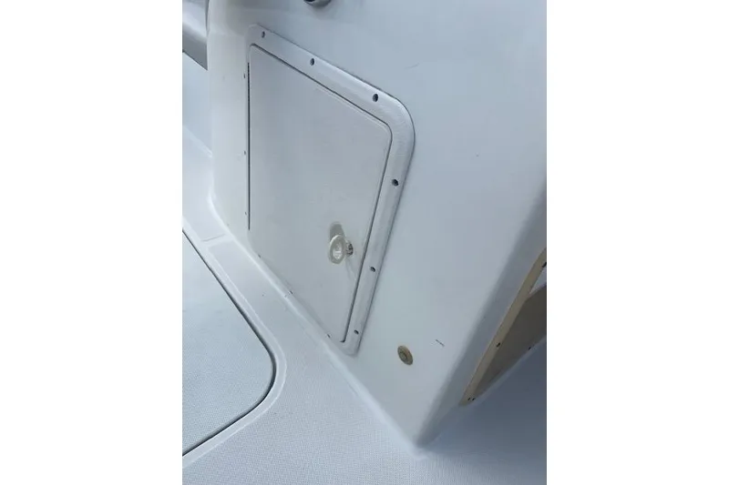 Slide: The Image of 2017 Hurricane SunDeck Sport 188 OB boat interior at marina, with docked boats and people. - 7