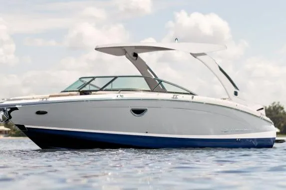 The Image of 2026 Regal LX6 boat on water, sleek design, white and blue exterior. - 0