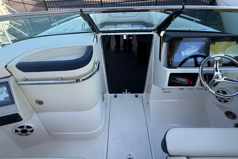 Slide: The Image of 2026 Regal LX6 boat interior with touchscreen, cup holder, and speaker. - 25