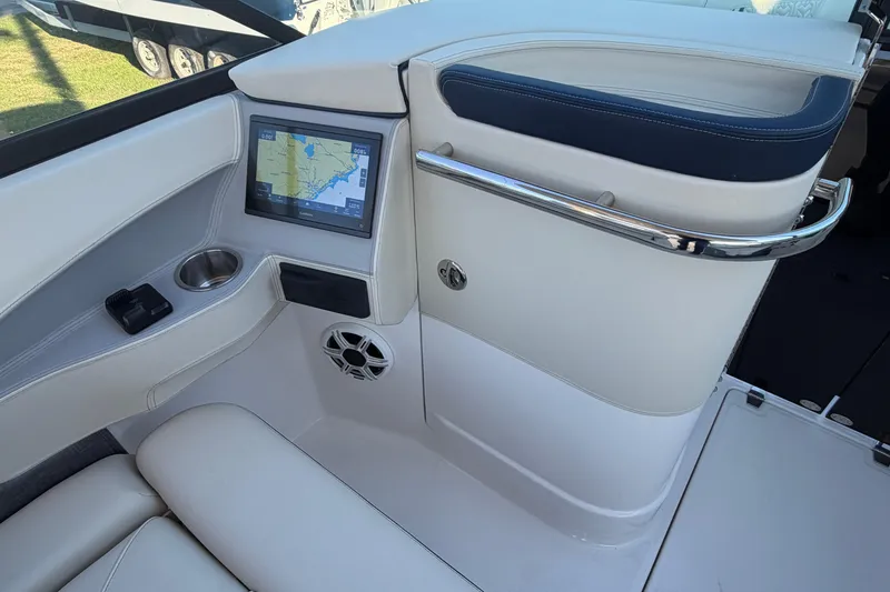 Slide: The Image of 2026 Regal LX6 boat interior with navigation screen and cup holder. - 27