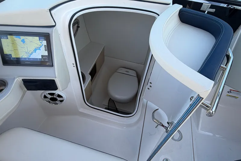 Slide: The Image of 2026 Regal LX6 boat interior with compact bathroom and modern amenities. - 28