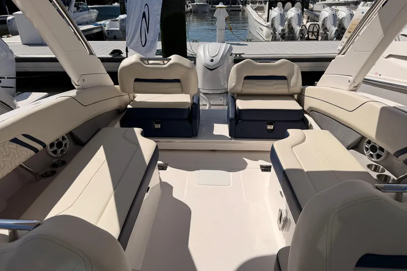 Slide: The Image of 2026 Regal LX6 boat interior with dual cushioned seats and storage compartments. - 38