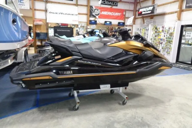 The Image of 2025 Yamaha WaveRunner FX Cruiser HO in showroom, black and gold design. - 0