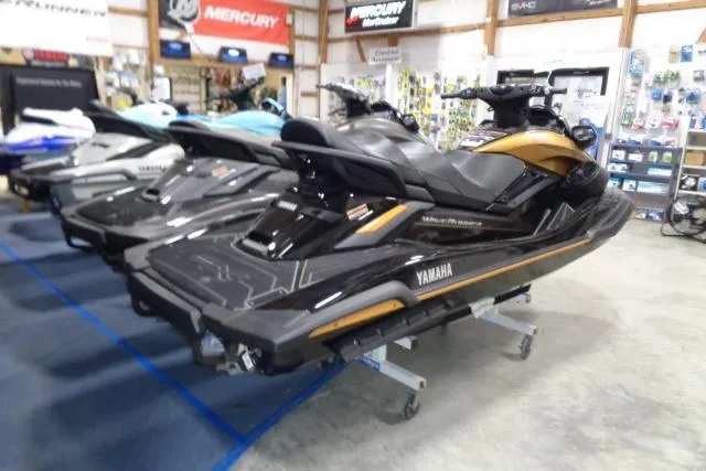 Slide: The Image of 2025 Yamaha WaveRunner FX Cruiser HO in showroom, sleek black and gold design. - 2