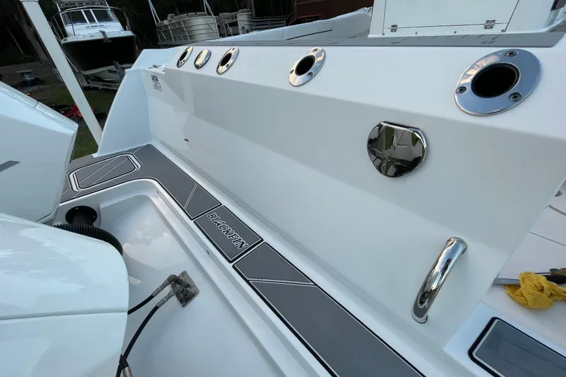 Slide: The Image of 2022 Blackfin 252 CC boat deck with rod holders and sleek design. - 12