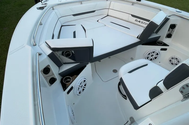Slide: The Image of 2022 Blackfin 252 CC boat interior with white seating and speaker system. - 15