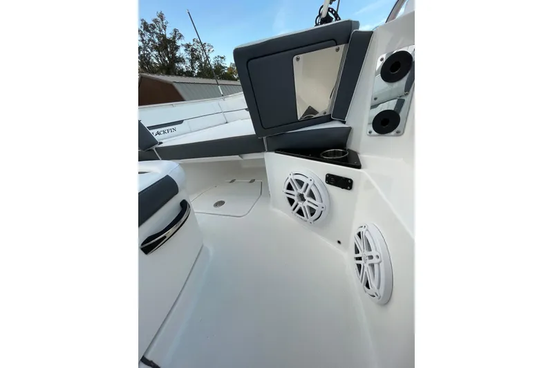 Slide: The Image of 2022 Blackfin 252 CC boat interior with speakers and seating area. - 16