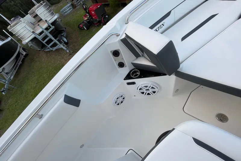 Slide: The Image of 2022 Blackfin 252 CC boat interior with seating and speakers, showcasing modern design. - 17
