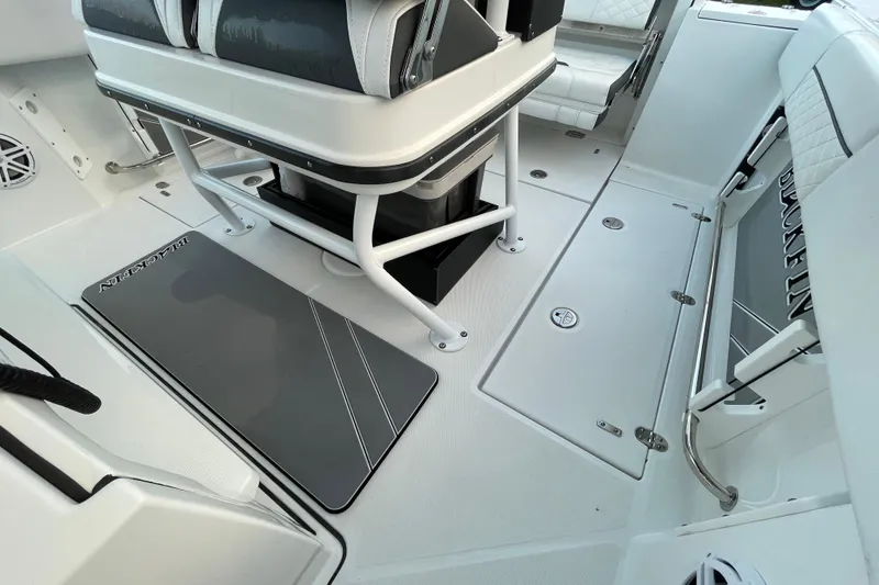 Slide: The Image of 2022 Blackfin 252 CC boat interior with seating and storage compartments. - 21