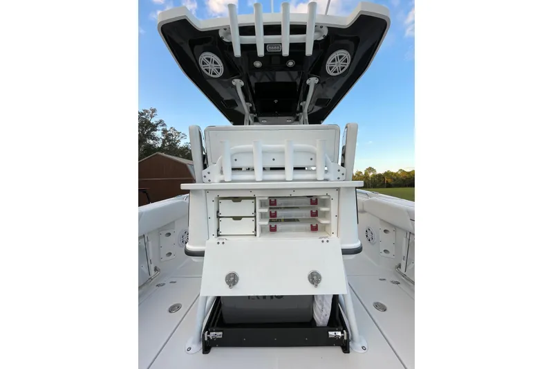 Slide: The Image of 2022 Blackfin 252 CC boat with open storage compartments and rod holders. - 25