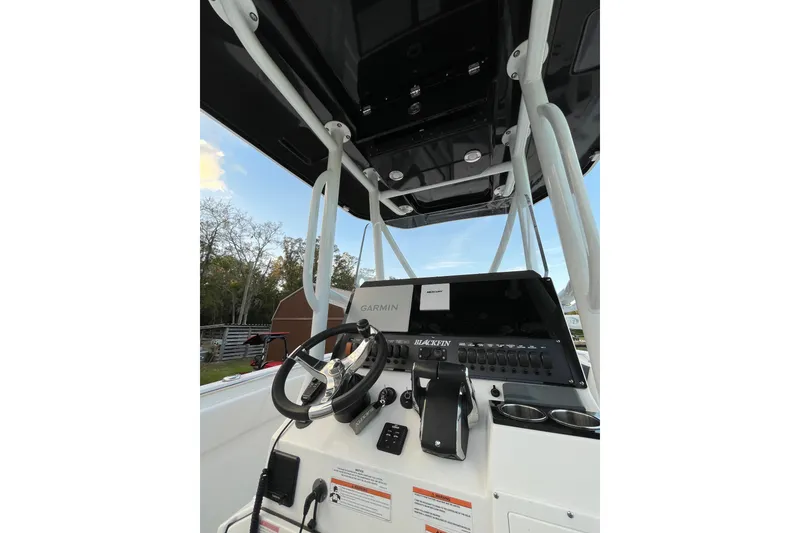 Slide: The Image of 2022 Blackfin 252 CC boat console with Garmin navigation system and steering wheel. - 29