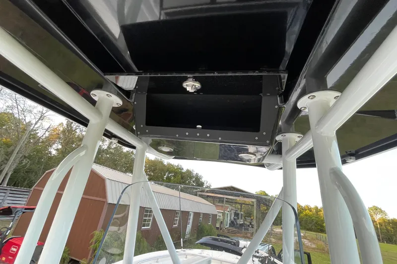 Slide: The Image of 2022 Blackfin 252 CC boat T-top interior view with storage compartment. - 30
