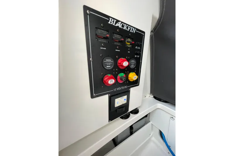 Slide: The Image of Control panel of 2022 Blackfin 252 CC boat, featuring switches and indicators. - 34