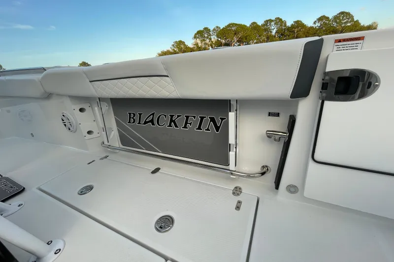 Slide: The Image of 2022 Blackfin 252 CC boat interior with branded storage compartment and sleek design. - 40