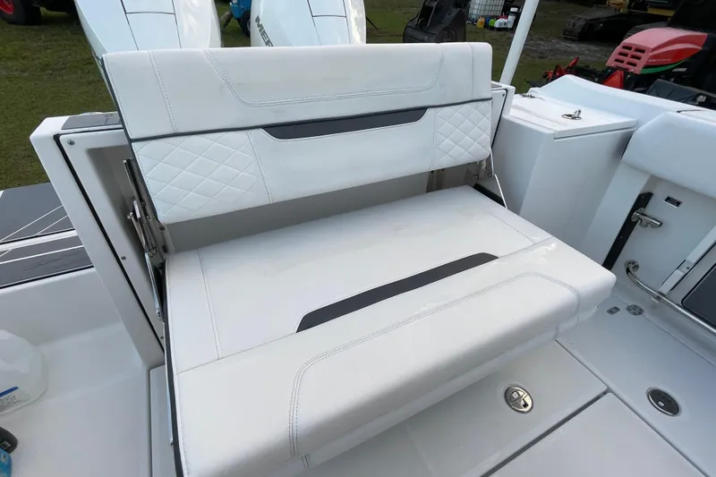 Slide: The Image of 2022 Blackfin 252 CC boat with white cushioned seating and storage compartment. - 43