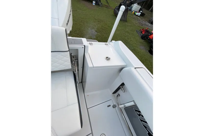 Slide: The Image of 2022 Blackfin 252 CC boat interior with white seating and storage compartments. - 44