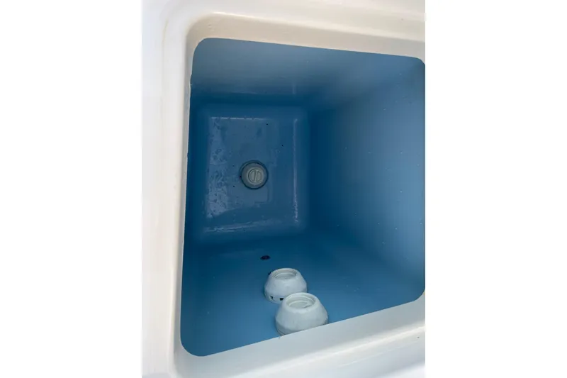 Slide: The Image of Interior view of a 2022 Blackfin 252 CC boat compartment, featuring a blue finish. - 45