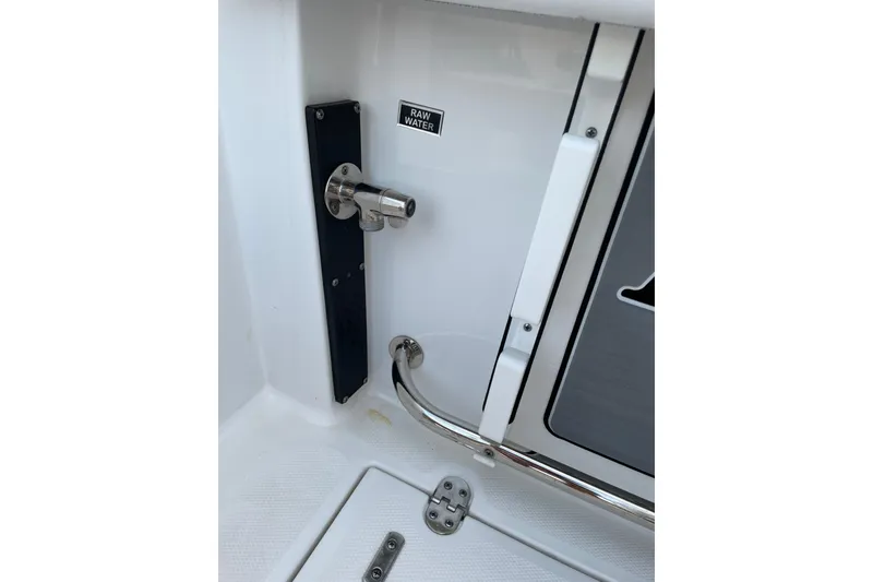Slide: The Image of 2022 Blackfin 252 CC boat raw water outlet and stainless steel fittings. - 46