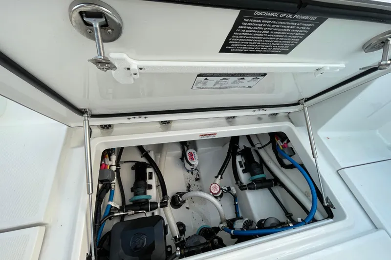 Slide: The Image of 2022 Blackfin 252 CC boat compartment with visible wiring and components. - 50