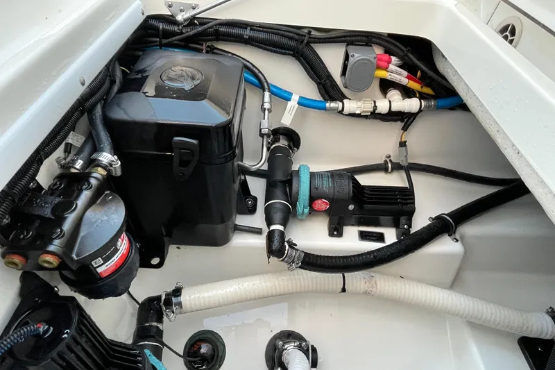 Slide: The Image of 2022 Blackfin 252 CC boat engine compartment with wiring and components. - 51