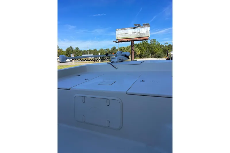 Slide: The Image of 2020 Carolina Skiff 21 LS boat deck with clear blue sky and billboard in background. - 10