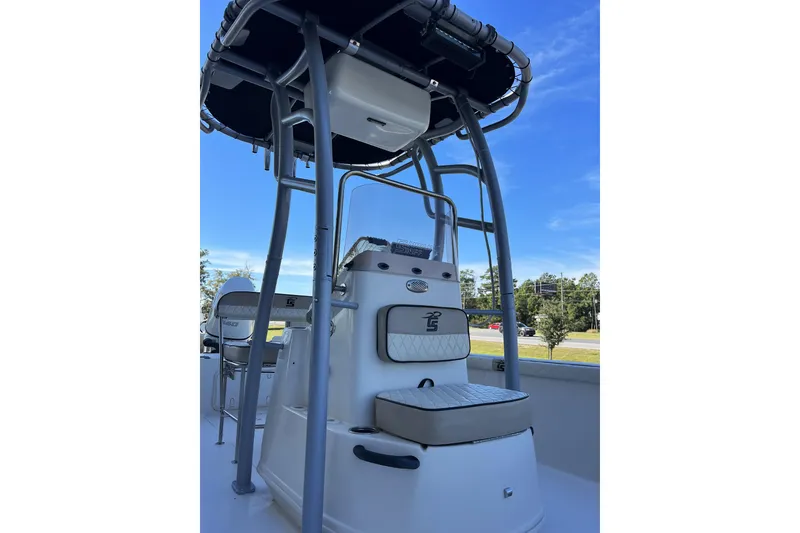 Slide: The Image of 2020 Carolina Skiff 21 LS boat interior with seating and T-top under clear blue sky. - 11