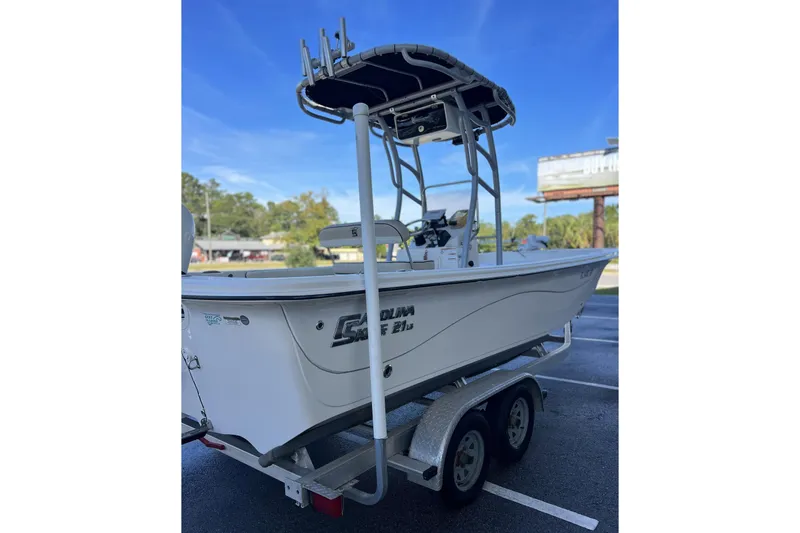 Slide: The Image of 2020 Carolina Skiff 21 LS boat on trailer, parked outdoors under clear sky. - 14