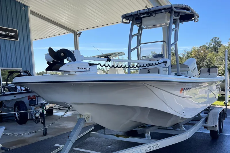 Slide: The Image of 2020 Carolina Skiff 21 LS boat on trailer under canopy, featuring Minn Kota Terrova motor. - 17