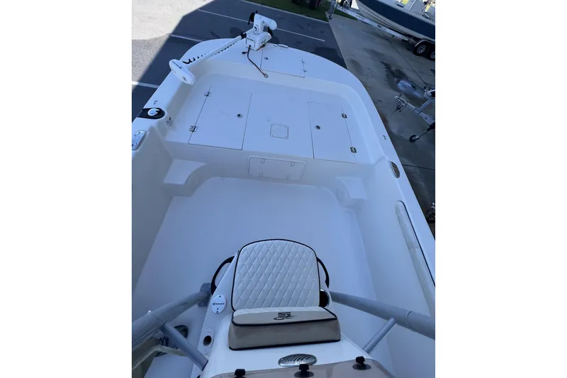 Slide: The Image of 2020 Carolina Skiff 21 LS boat interior with white seating and storage compartments. - 3