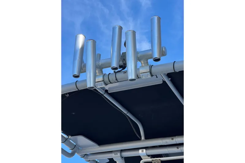 Slide: The Image of Rod holders on a 2020 Carolina Skiff 21 LS boat against a clear blue sky. - 4