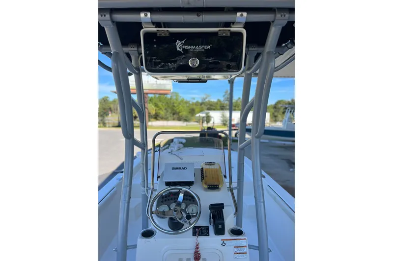 Slide: The Image of 2020 Carolina Skiff 21 LS boat interior with steering wheel and navigation equipment. - 7