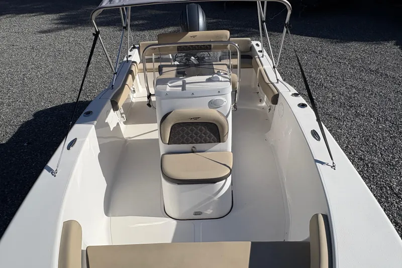 Slide: The Image of 2022 Tidewater 180 CC Adventure boat with beige seating and center console. - 10