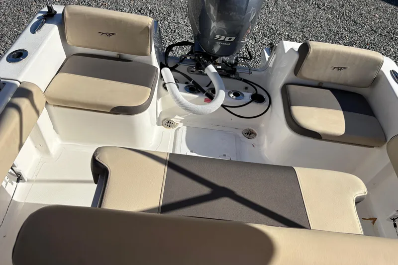 Slide: The Image of 2022 Tidewater 180 CC Adventure boat interior with Yamaha 90 engine, beige seating. - 8