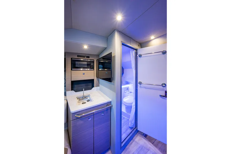 Slide: The Image of 2022 Formula 380 Super Sport Crossover OB interior with kitchenette and bathroom. - 13