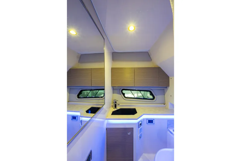 Slide: The Image of Interior of 2022 Formula 380 Super Sport Crossover OB, featuring modern cabinetry and lighting. - 14