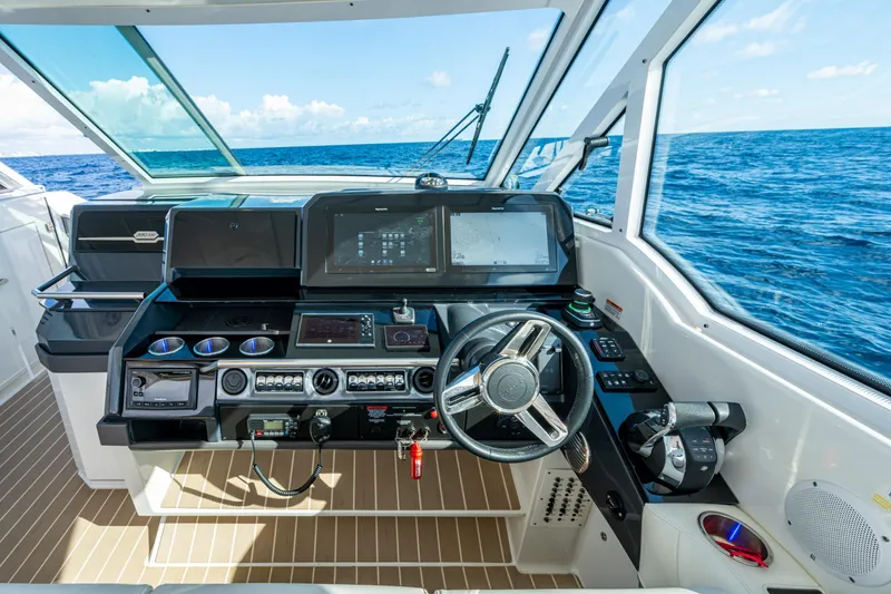 Slide: The Image of 2022 Formula 380 Super Sport Crossover OB helm with advanced navigation system, ocean view. - 2