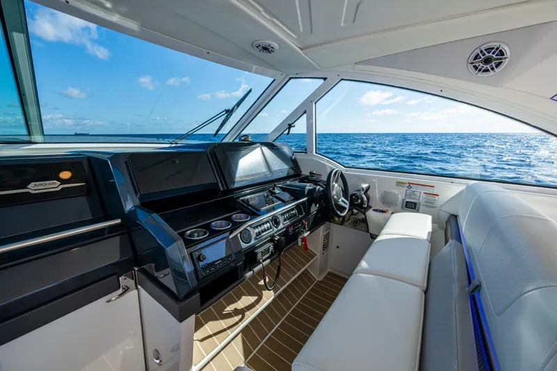 Slide: The Image of 2022 Formula 380 Super Sport Crossover OB interior with ocean view, featuring modern helm and seating. - 28