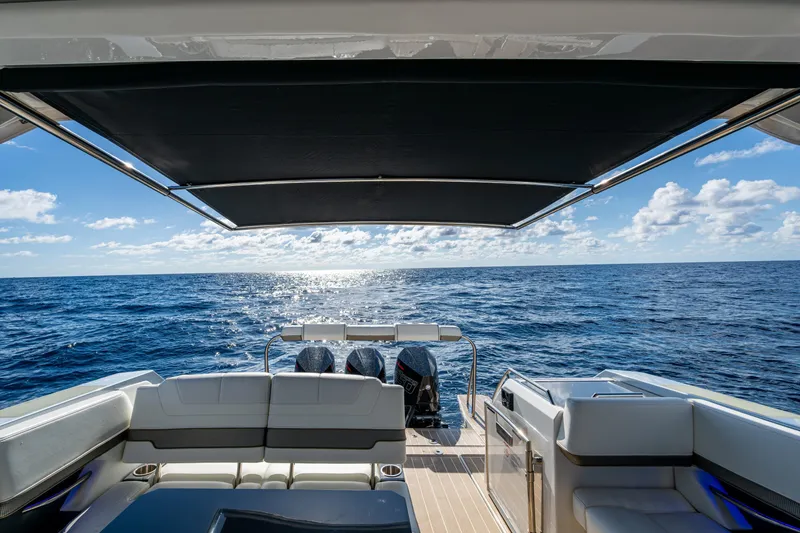 Slide: The Image of 2022 Formula 380 Super Sport Crossover OB on open sea, featuring luxurious seating and canopy. - 32