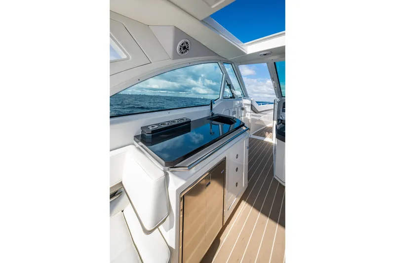 Slide: The Image of Interior of 2022 Formula 380 Super Sport Crossover OB, featuring sleek kitchen and ocean view. - 35