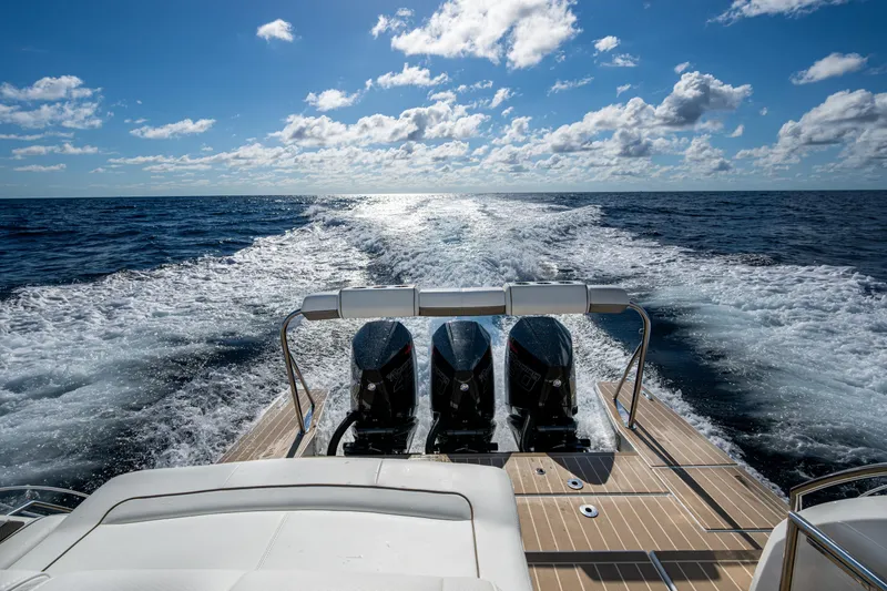 Slide: The Image of 2022 Formula 380 Super Sport Crossover OB cruising on open ocean under blue sky. - 36