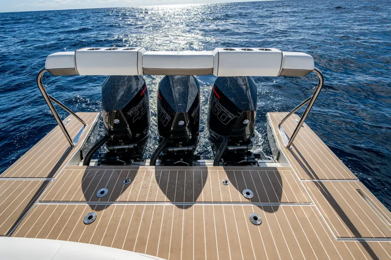 Slide: The Image of 2022 Formula 380 Super Sport Crossover OB with triple outboard engines on open water. - 9