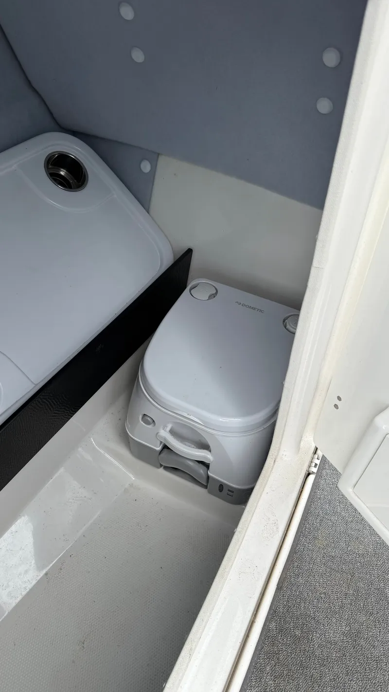 Slide: The Image of Portable toilet inside 2019 Yamaha AR240 boat compartment. - 12