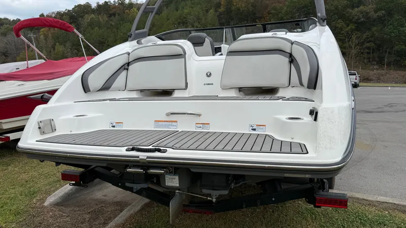 Slide: The Image of 2019 Yamaha Boats AR240 rear view with swim platform and seating. - 2