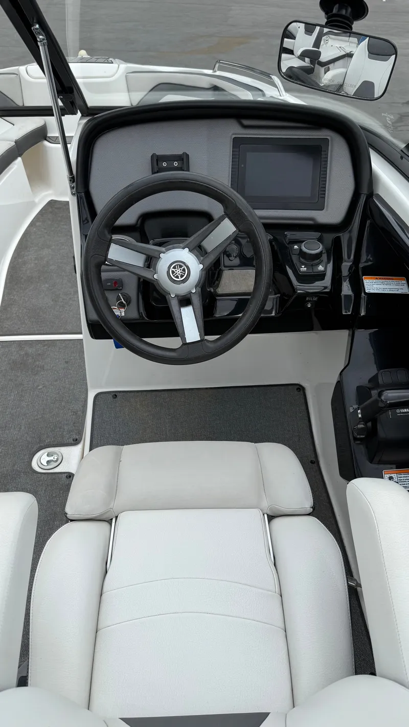 Slide: The Image of 2019 Yamaha AR240 boat cockpit with steering wheel and control panel. - 4