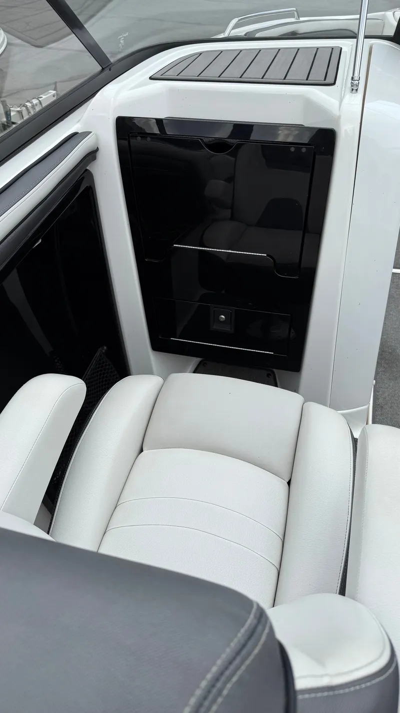 Slide: The Image of 2019 Yamaha Boats AR240 interior with white seating and sleek black panel. - 5