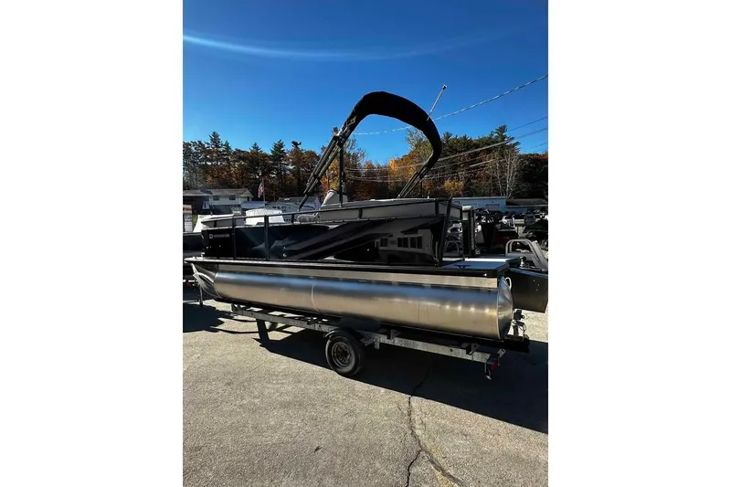 Slide: The Image of 2026 DOCKSIDE 20DQ pontoon boat on trailer under clear blue sky. - 2